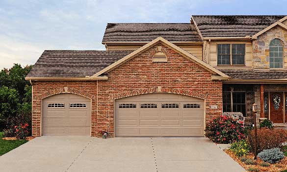 brown house with two garage doors